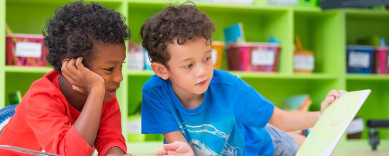 two young boys reading books