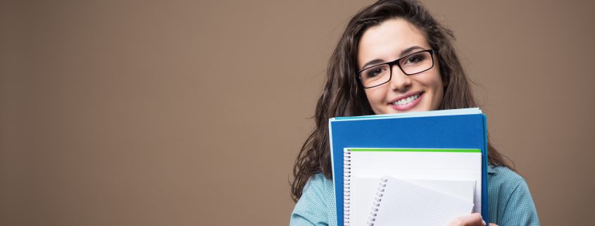 high schooler with notebooks