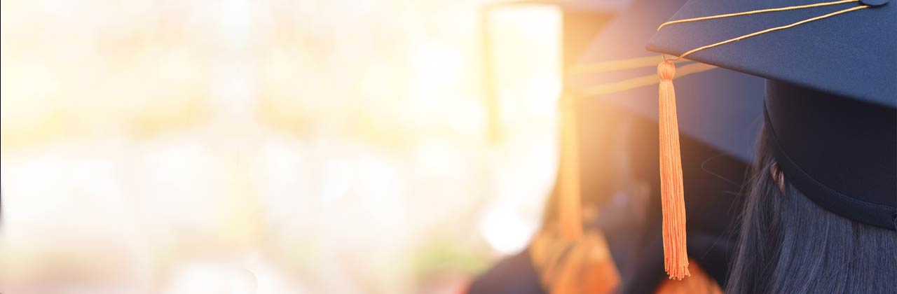 high school graduates in caps and gowns