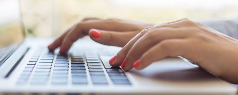 hands typing on a laptop